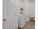 Well-lit laundry room with washer, dryer, utility sink, and tile flooring at 809 Circle Trace Rd, Monroe, NC 28110