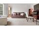 Comfortable living room featuring a brown leather sofa, grandfather clock and a bright window at 809 Circle Trace Rd, Monroe, NC 28110
