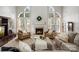 Inviting living room with high ceilings, large windows, and a cozy fireplace at 809 Circle Trace Rd, Monroe, NC 28110