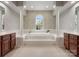 Main bathroom features a soaking tub with decorative columns, tile floors, and dual vanities at 809 Circle Trace Rd, Monroe, NC 28110