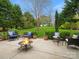 Cozy patio setting with a crackling fire pit, comfortable seating, and serene backyard views at 809 Circle Trace Rd, Monroe, NC 28110