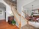Carpeted staircase with wooden railing, leading to an open dining area with elegant furniture at 809 Circle Trace Rd, Monroe, NC 28110