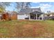 Fenced backyard featuring a covered patio and playset, perfect for outdoor fun at 8721 Brampton Dr, Charlotte, NC 28215