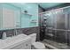 Modern bathroom boasts sleek vanity, stylish mirror, and updated walk-in glass shower at 8721 Brampton Dr, Charlotte, NC 28215