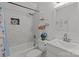 Bright bathroom with a shower-tub combo, modern sink, and decorative accents at 8721 Brampton Dr, Charlotte, NC 28215