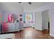 bedroom includes light purple walls, wood floors, dresser, and a window nook at 8721 Brampton Dr, Charlotte, NC 28215