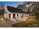 Charming single-story home with red brick accents, white columns and inviting front porch at 8721 Brampton Dr, Charlotte, NC 28215