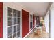 Charming front porch featuring classic red brick accents and inviting rocking chairs at 8721 Brampton Dr, Charlotte, NC 28215
