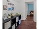 Hallway features dark hardwood floors, decorated shelf, and light walls at 8721 Brampton Dr, Charlotte, NC 28215
