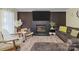 Cozy living room boasts wood floors, a modern fireplace, and stylish furniture at 8721 Brampton Dr, Charlotte, NC 28215