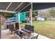 Covered patio area with patio seating and grill, ideal for outdoor entertaining at 8721 Brampton Dr, Charlotte, NC 28215