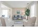 Stylish living room featuring a comfortable sofa, decorative pillows, and an elegant glass coffee table, bathed in natural light at 8823 Deerland Ct, Huntersville, NC 28078