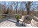 Outdoor deck featuring seating overlooking a lush, wooded backyard at 9036 Saint Thomas Ln, Charlotte, NC 28277