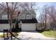 Inviting gray two-story townhouse featuring an attached two car garage and lush lawn at 9036 Saint Thomas Ln, Charlotte, NC 28277