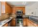 Updated kitchen featuring stainless appliances, granite counters, and ample cabinet space at 9036 Saint Thomas Ln, Charlotte, NC 28277