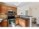 Kitchen featuring stainless appliances, granite counters, and seamless flow to dining area at 9036 Saint Thomas Ln, Charlotte, NC 28277