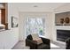 Cozy living room with a fireplace and sliding glass doors to the outdoor deck at 9036 Saint Thomas Ln, Charlotte, NC 28277