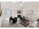 Cozy living room featuring a fireplace, skylights, neutral decor, and a sliding glass door to the deck at 9036 Saint Thomas Ln, Charlotte, NC 28277