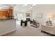 Cozy living room with a fireplace, skylights, neutral decor, and a sliding glass door to the deck at 9036 Saint Thomas Ln, Charlotte, NC 28277