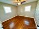 Bedroom with hardwood floors, neutral paint and two bright, sunny windows at 911 Union Ter, Gastonia, NC 28056