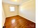 Cozy bedroom featuring hardwood floors, neutral walls, and a window for natural light and comfort at 911 Union Ter, Gastonia, NC 28056