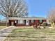 Charming red brick home with a well-manicured lawn and a covered carport, perfect for suburban living at 911 Union Ter, Gastonia, NC 28056