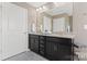 Bathroom with double sink vanity, granite countertops, and dark wood cabinetry at 919 Pennington Dr, Indian Land, SC 29720