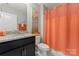 Stylish bathroom featuring a granite countertop vanity and modern, colorful shower curtain at 919 Pennington Dr, Indian Land, SC 29720