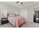 Serene bedroom with a plush bed, neutral color palette, and two windows providing ample natural light at 919 Pennington Dr, Indian Land, SC 29720