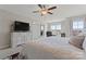Bright bedroom with a ceiling fan, large bed, and a window overlooking the yard at 919 Pennington Dr, Indian Land, SC 29720