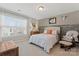Cozy bedroom featuring a large window, decorative wall accents, and comfortable furnishings at 919 Pennington Dr, Indian Land, SC 29720