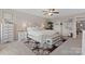 Cozy bedroom features a tufted headboard, a ceiling fan, and a decorative rug at 919 Pennington Dr, Indian Land, SC 29720