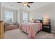 Cozy bedroom featuring neutral walls, carpet, and a comfortable bed with pink and gray accents at 919 Pennington Dr, Indian Land, SC 29720