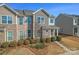 Attractive townhome showcasing a combination of stone and siding accents with manicured landscaping at 919 Pennington Dr, Indian Land, SC 29720