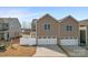 Exterior view of a home with a two-car garage and well-manicured landscaping at 919 Pennington Dr, Indian Land, SC 29720