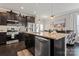 Kitchen boasts stainless appliances, an island with granite countertop, and modern lighting fixtures at 919 Pennington Dr, Indian Land, SC 29720