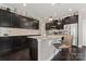 Well-appointed kitchen features dark cabinetry, granite countertops, and a stainless steel refrigerator at 919 Pennington Dr, Indian Land, SC 29720
