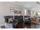 Sitting area featuring dark hardwood floors, stylish chairs, and view into dining area at 919 Pennington Dr, Indian Land, SC 29720