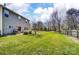Expansive backyard featuring a lush lawn, a wooden deck, mature trees, and a partial privacy fence at 10436 Cullen Ct, Charlotte, NC 28278