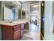 Bathroom vanity with a granite countertop and view to the office space with hardwood floors at 10436 Cullen Ct, Charlotte, NC 28278