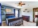 Bedroom with blue accent wall, ceiling fan, carpet and a large bed at 10436 Cullen Ct, Charlotte, NC 28278