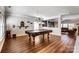 Spacious game room with hardwood floors and a pool table, perfect for entertaining at 10436 Cullen Ct, Charlotte, NC 28278