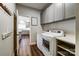 Spacious laundry room with grey cabinets and stainless steel washer and dryer at 10436 Cullen Ct, Charlotte, NC 28278