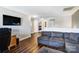 Upstairs living area featuring wood floors, a grey sofa and views of bedrooms at 10436 Cullen Ct, Charlotte, NC 28278