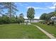 Lush backyard featuring a pool, patio, and pathway leading to the home at 106 Beachview Dr, Mooresville, NC 28117