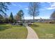 Lush backyard features a swimming pool, lounge chairs, water access, and beautiful landscaping at 106 Beachview Dr, Mooresville, NC 28117