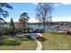 Spacious backyard with in-ground pool, lounge chairs, and lake views at 106 Beachview Dr, Mooresville, NC 28117