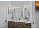 Bathroom with a well-lit mirror, vanity, and modern fixtures at 106 Beachview Dr, Mooresville, NC 28117