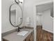 Bathroom featuring a wood vanity, neutral walls and flooring, and modern fixtures at 106 Beachview Dr, Mooresville, NC 28117