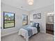 Bright bedroom featuring two windows, neutral walls, plush carpet, and a view of the outdoors at 106 Beachview Dr, Mooresville, NC 28117